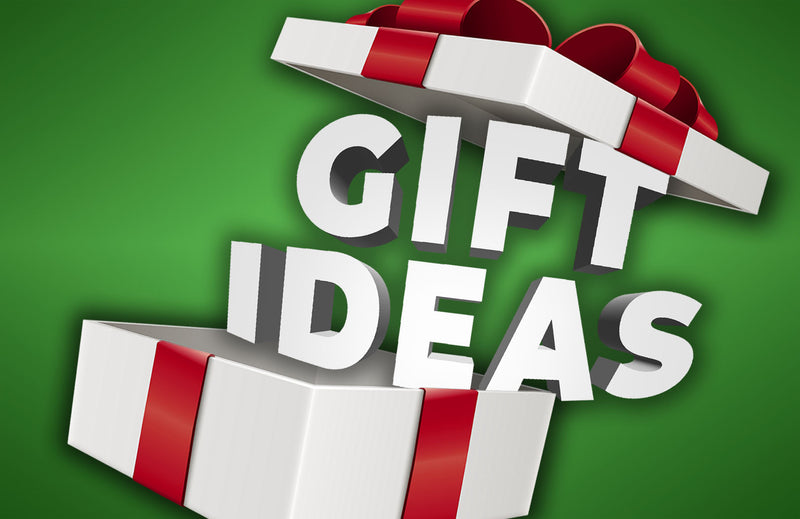 Gift ideas banner featuring drumsticks, a practice pad, and a cymbal displayed on a wooden surface with a festive ribbon, suggesting gift options for drummers.